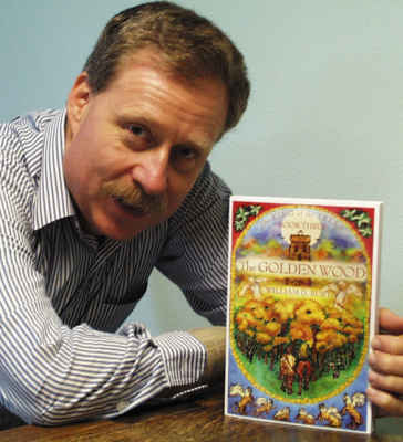 The author holding Book 3 in his series.